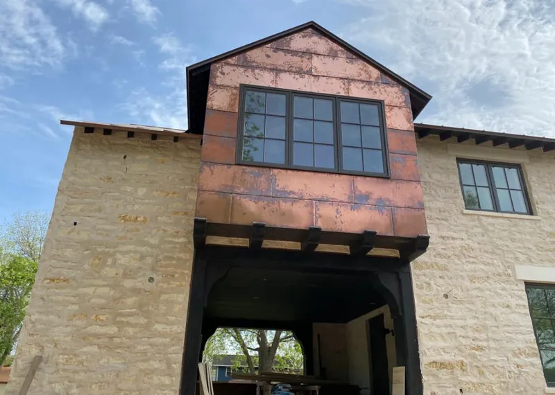 Copper metal panel facade on a stone building for Skylight Installation in Westbury